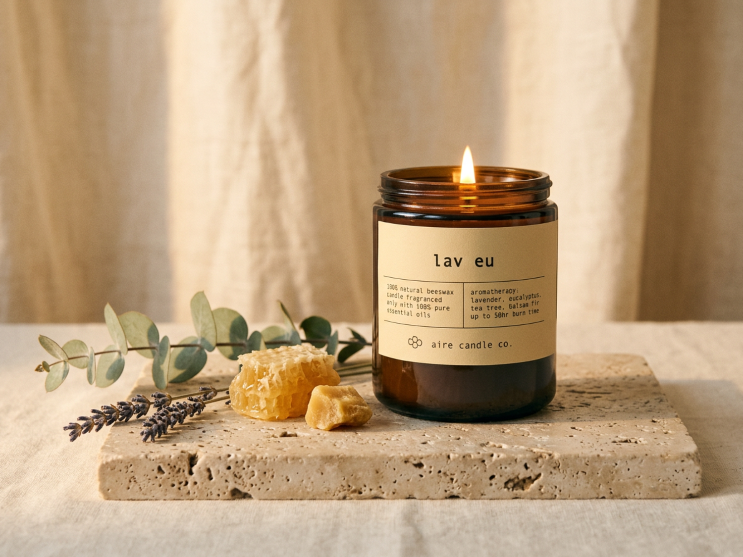 A lit candle labeled 'lav eu' on a stone surface with lavender and honeycomb.