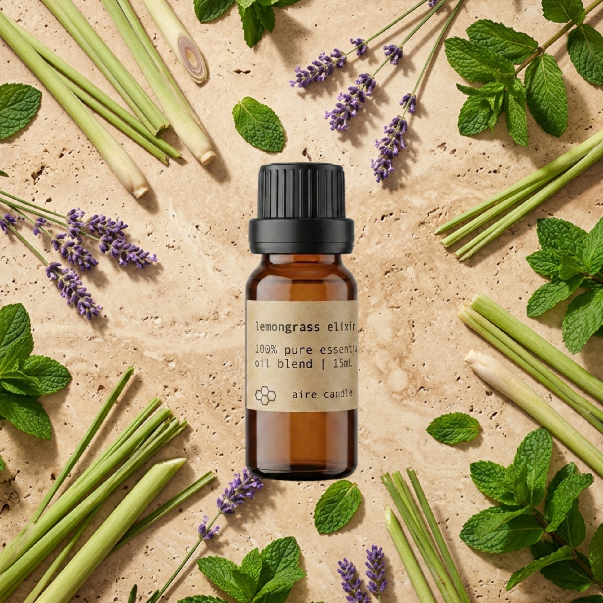 Bottle of Aire Candle Co. Lemongrass Elixir Essential Oil Blend Surrounded by Scent Notes of Lemongrass, Lavender & Peppermint Essential Oils on a Travertine Surface.