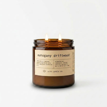 Mahogany Driftwood beeswax candle in a 16 oz amber jar with a label on a white background