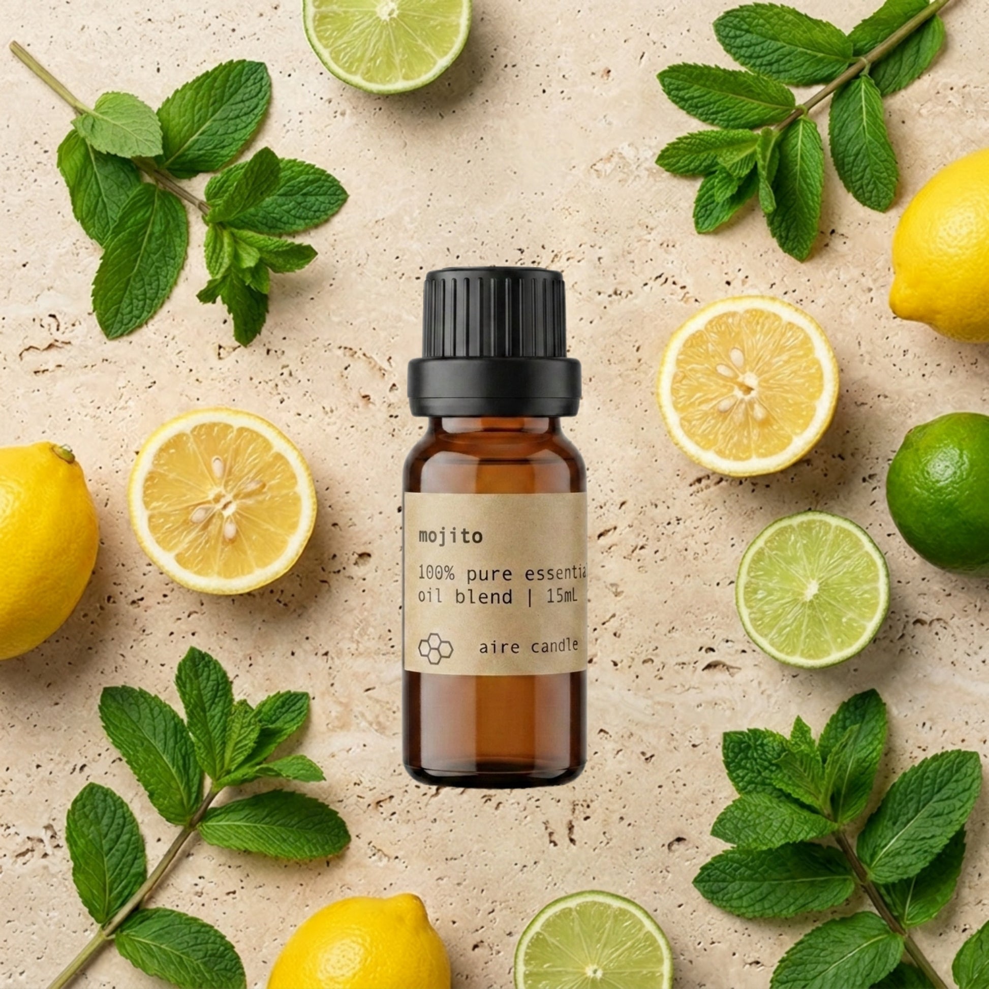 Bottle of Aire Candle Co. Mojito Essential Oil Blend Surrounded by Scent Notes of Lime, Lemon and Spearmint Essential Oils on a Travertine Surface.