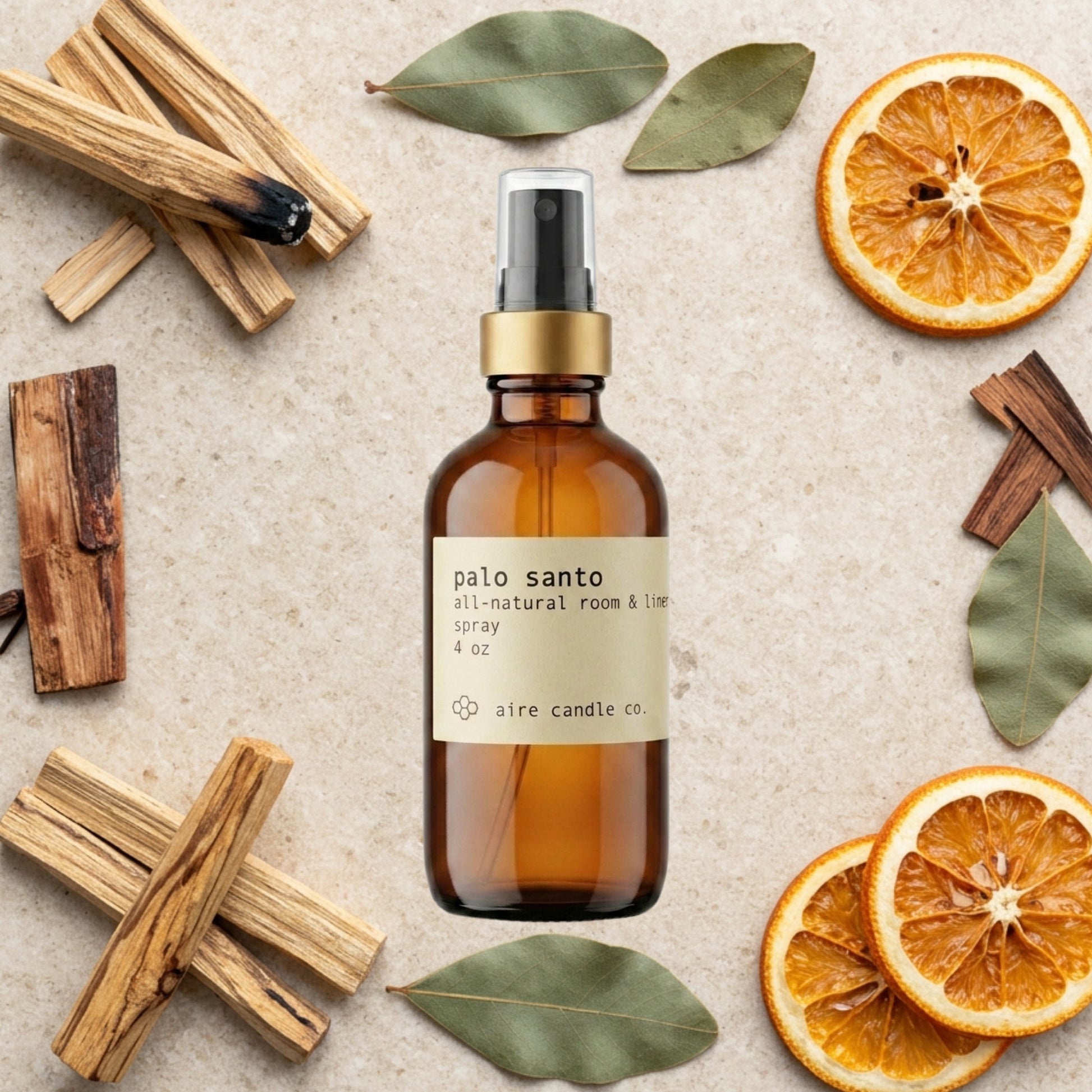 Aire Candle Co. Palo Santo Essential Oil Scented Room Spray Surrounded by Scent Notes of Palo Santo, Patchouli, Orange and Cedarwood Essential Oils.