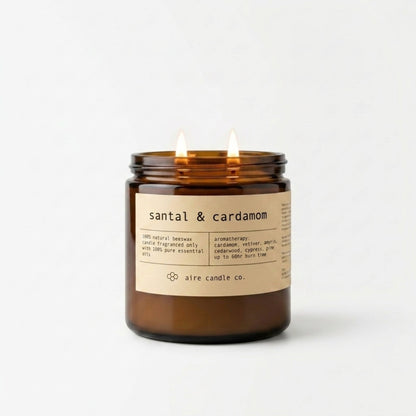 Santal & cardamom beeswax candle by aire candle co. housed in a 16 oz amber glass jar with two wicks.