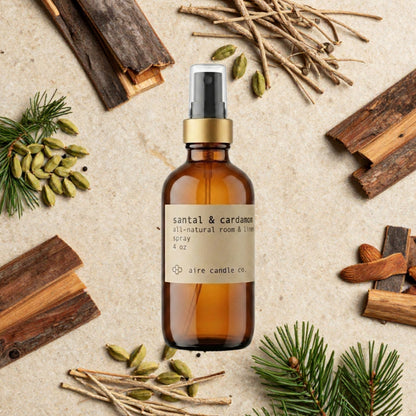 Aire Candle Co. Santal & Cardamom Essential Oil Scented Room Spray Surrounded by Scent Notes of Sandalwood, Cedarwood, Cardamom, Cypress, Pine Needles and Vetiver Essential Oils.