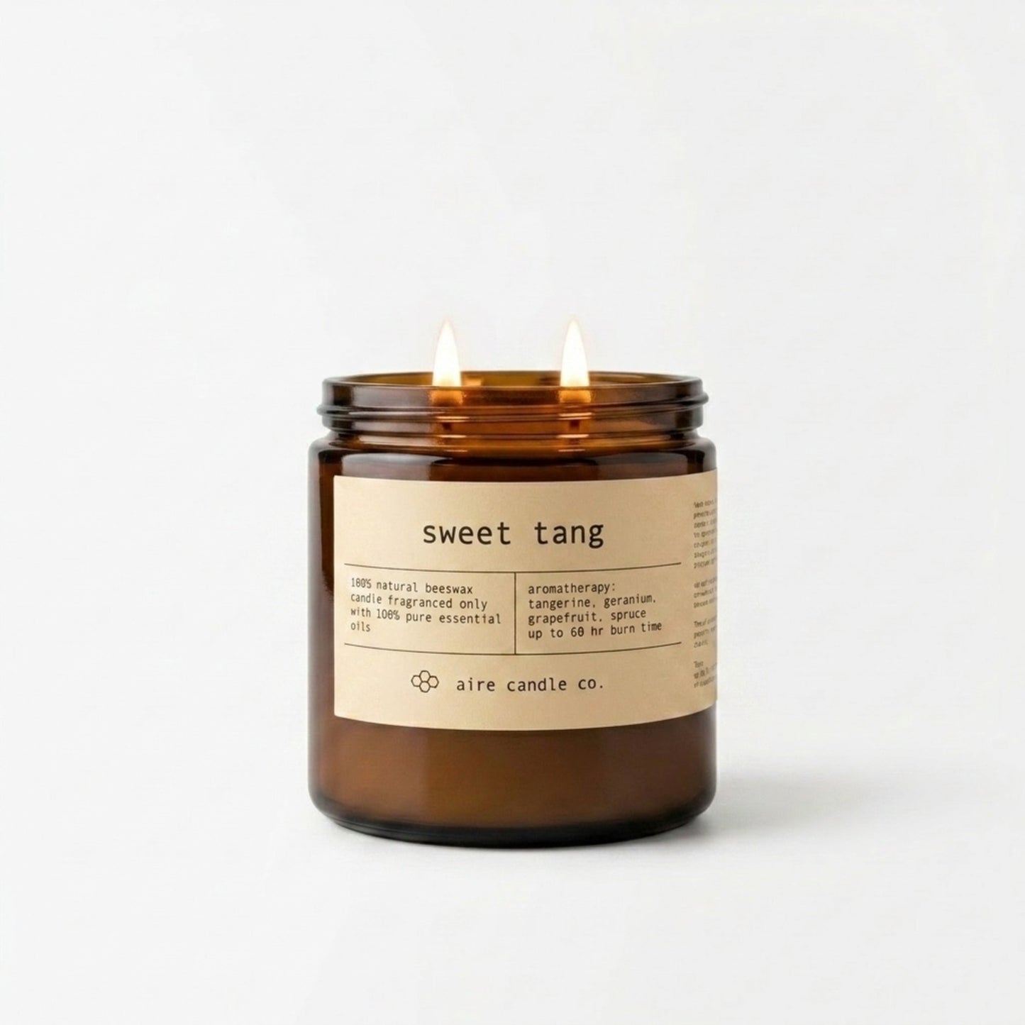 Sweet Tang beeswax candle in a 16 oz amber jar with a label on a white background