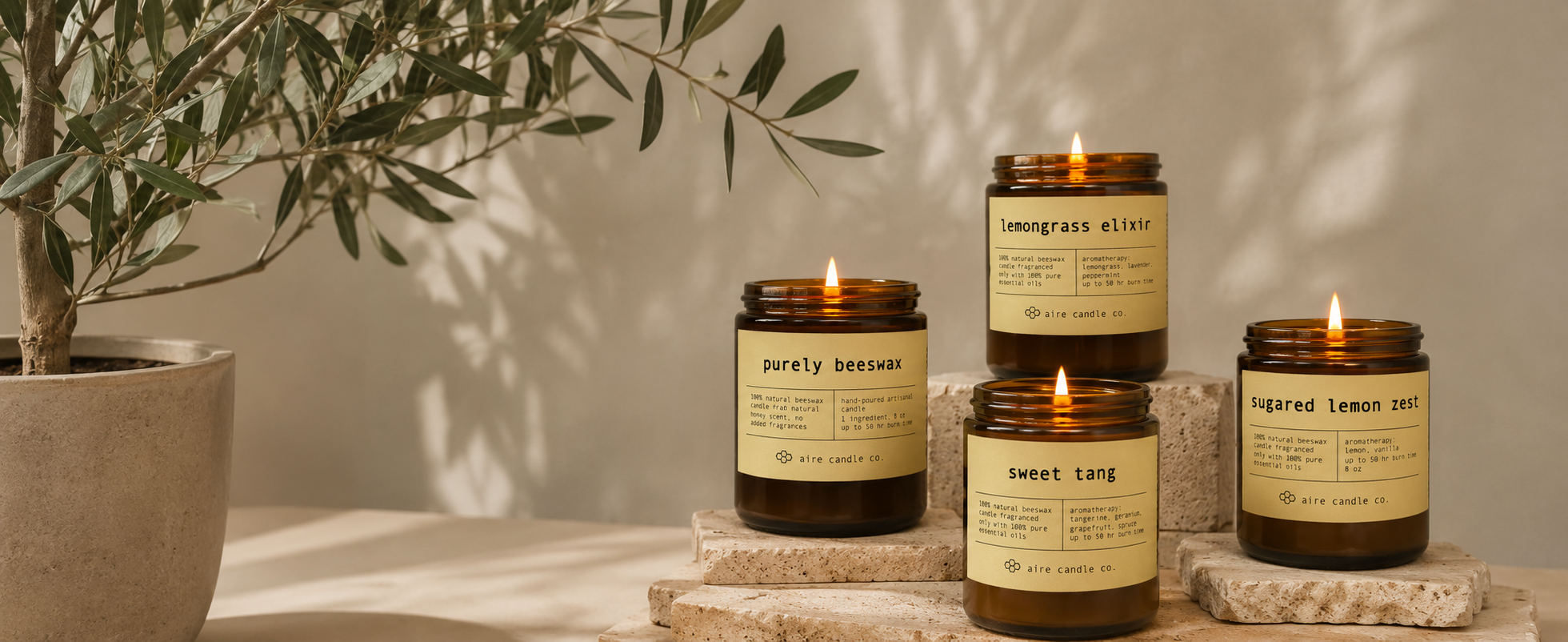 Set of all-natural beeswax candles by Aire Candle Co. on a stone surface next to a plant.