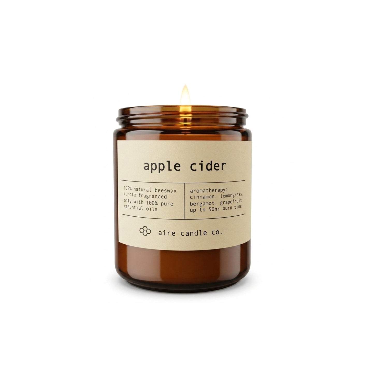 An amber glass jar candle with a lit wick, labeled 'apple cider' by aire candle co., on a clean white background.