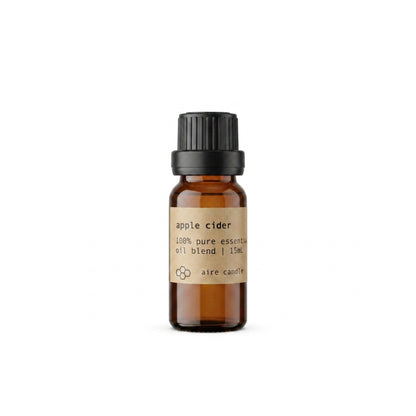 Brown apple cider essential oil bottle with a black cap on a white background