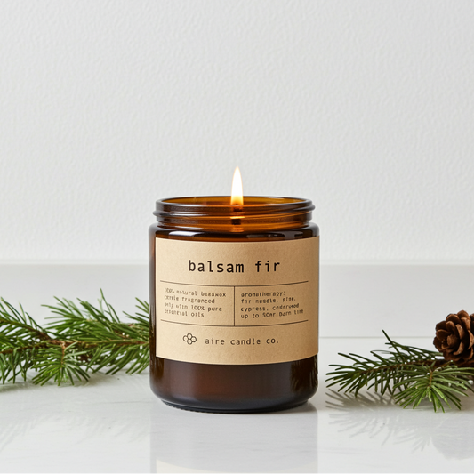 Balsam fir candle with a label on a white background with greenery and a pine cone.