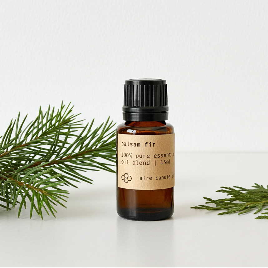 Bottle of balsam fir essential oil blend with a sprig of fir on a white background
