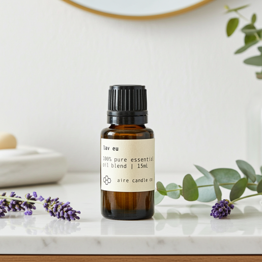 Essential oil bottle with lavender and eucalyptus flowers on a marble surface