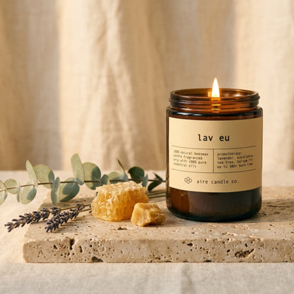 lav eu candle by aire candle co. with natural elements on a travertine surface.