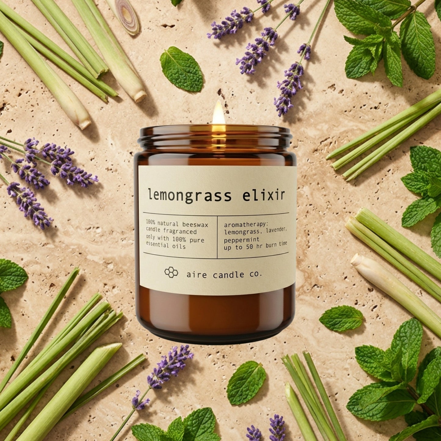 lemongrass elixir candle from aire candle co surrounded by lemongrass stalks, lavender and peppermint on a light travertine background.