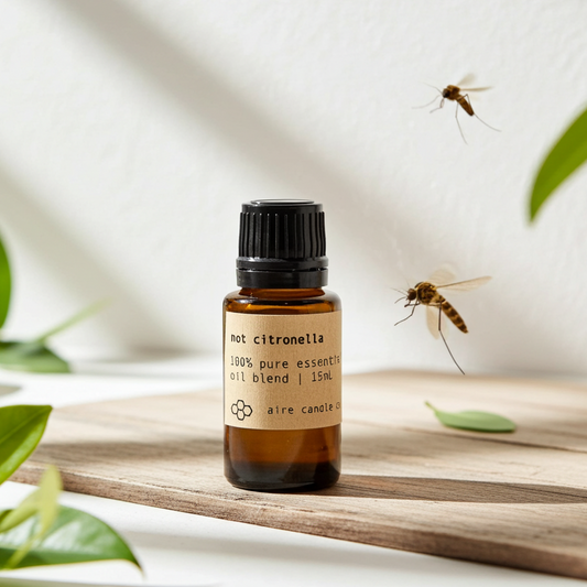 Bottle of citronella essential oil with a mosquito and leaves in the background