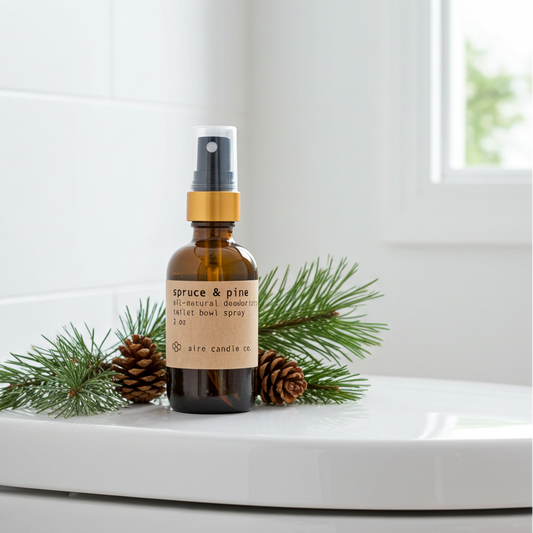 Bottle of spruce & pine toilet bowl spray on a toilet with evergreen scent notes