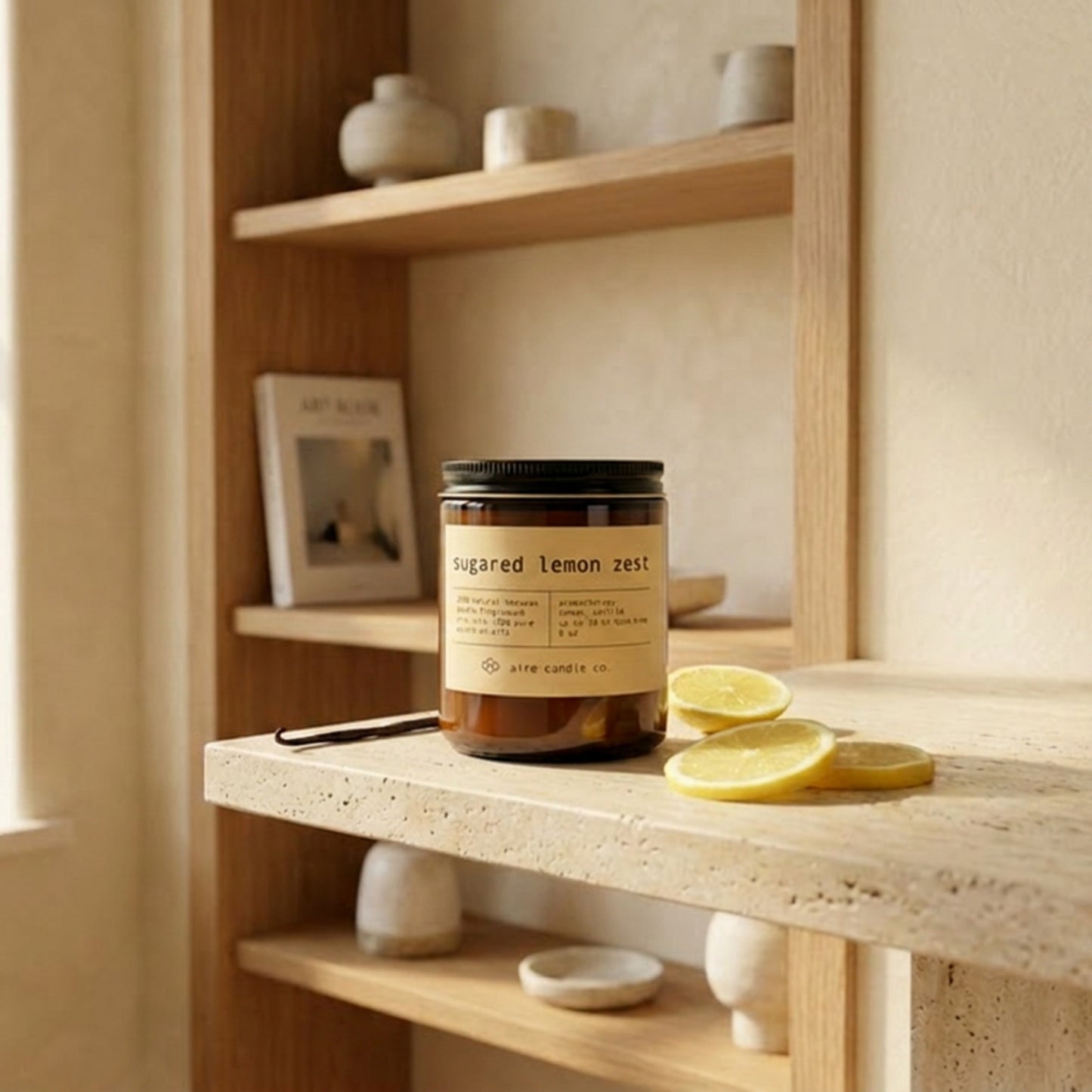 Jar of 'Sugared Lemon Zest' candle on a wooden shelf with lemon slices.