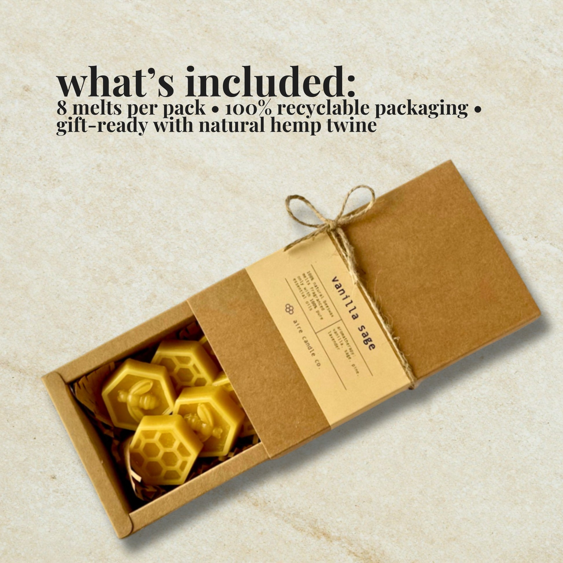 Box of hexagonal wax melts with vanilla sage scent, tied with twine on a textured beige background.