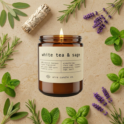 White tea & sage candle with herbs on a beige background
