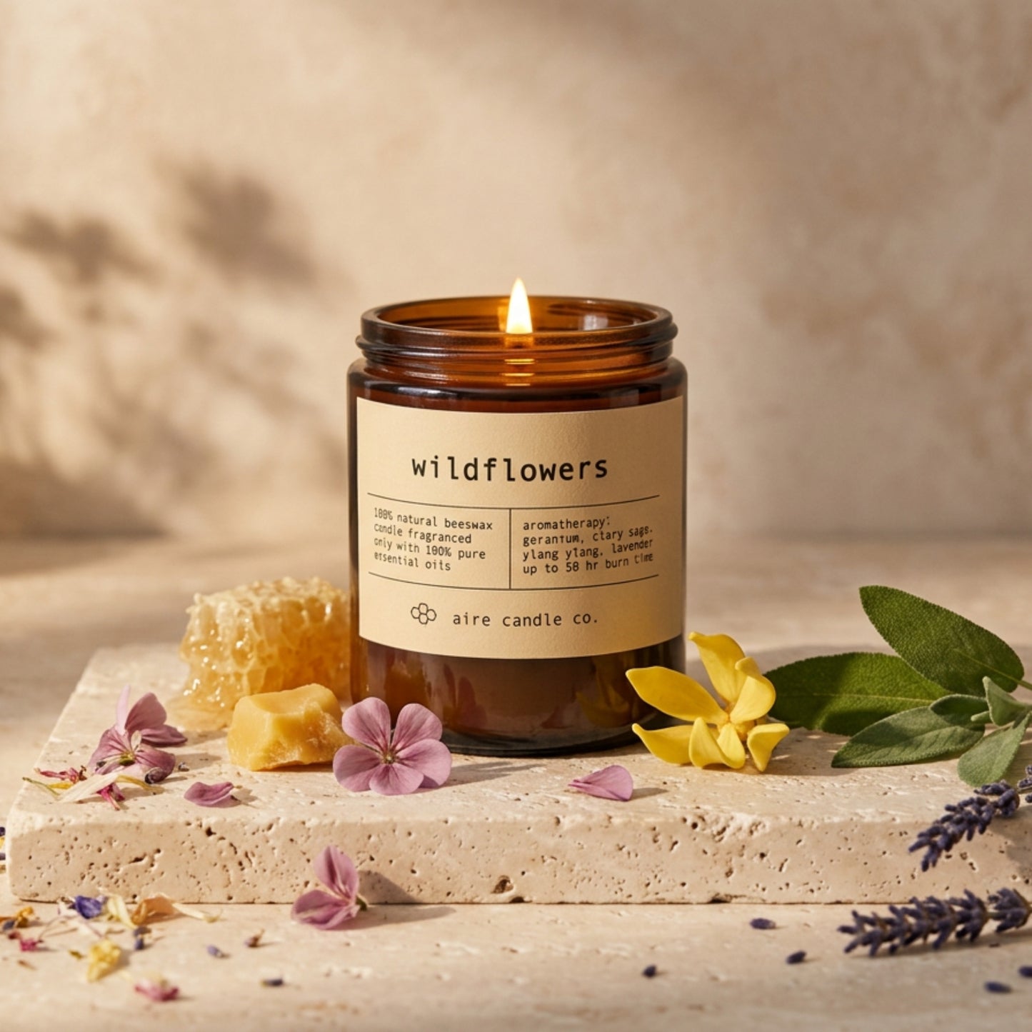Candle labeled 'Wildflowers' with floral elements on a neutral background